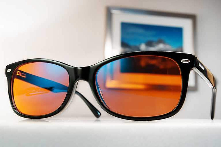 Black Classic Night Swannies Blue Light-blocking Glasses On Desk With Picture