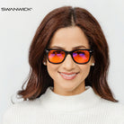 Woman wearing orange-tinted Sleep blue light glasses by Swanwick