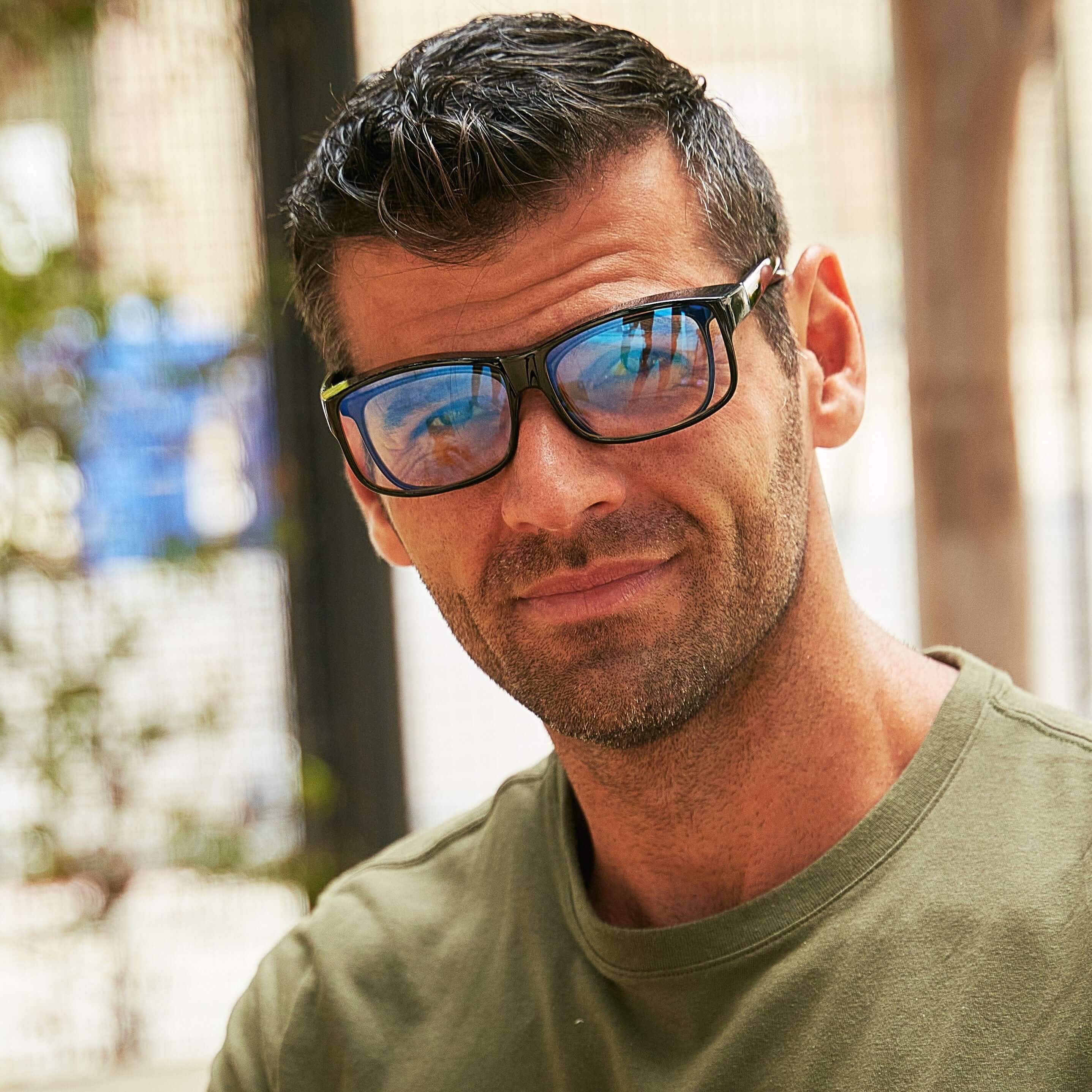 Man wearing fitover blue light blocking glasses over standard prescription glasses